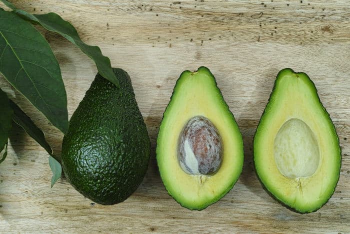 Image of whole and halved avocado