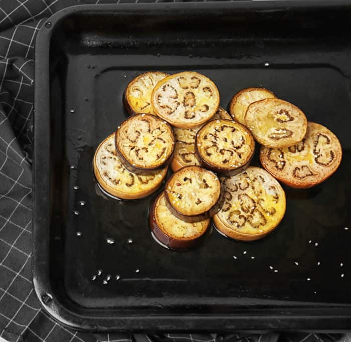 Sliced eggplant on baking tray