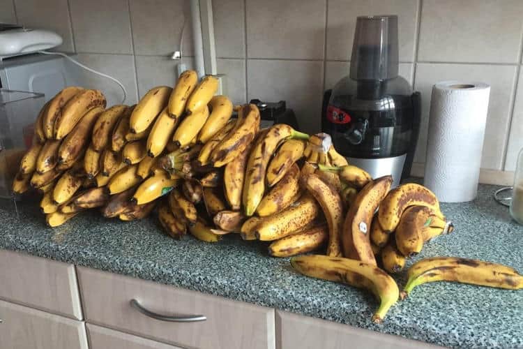 Large bunch of bananas on kitchen countertop