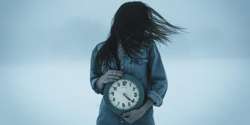 Woman holding a clock