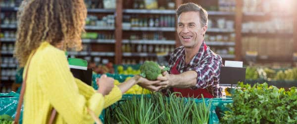 Lady purchasing fresh broccoli