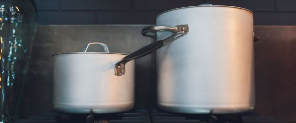 Two big cooking pots on a stove