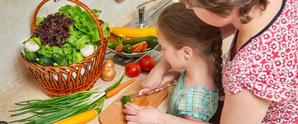 Mother and daughter preparing food