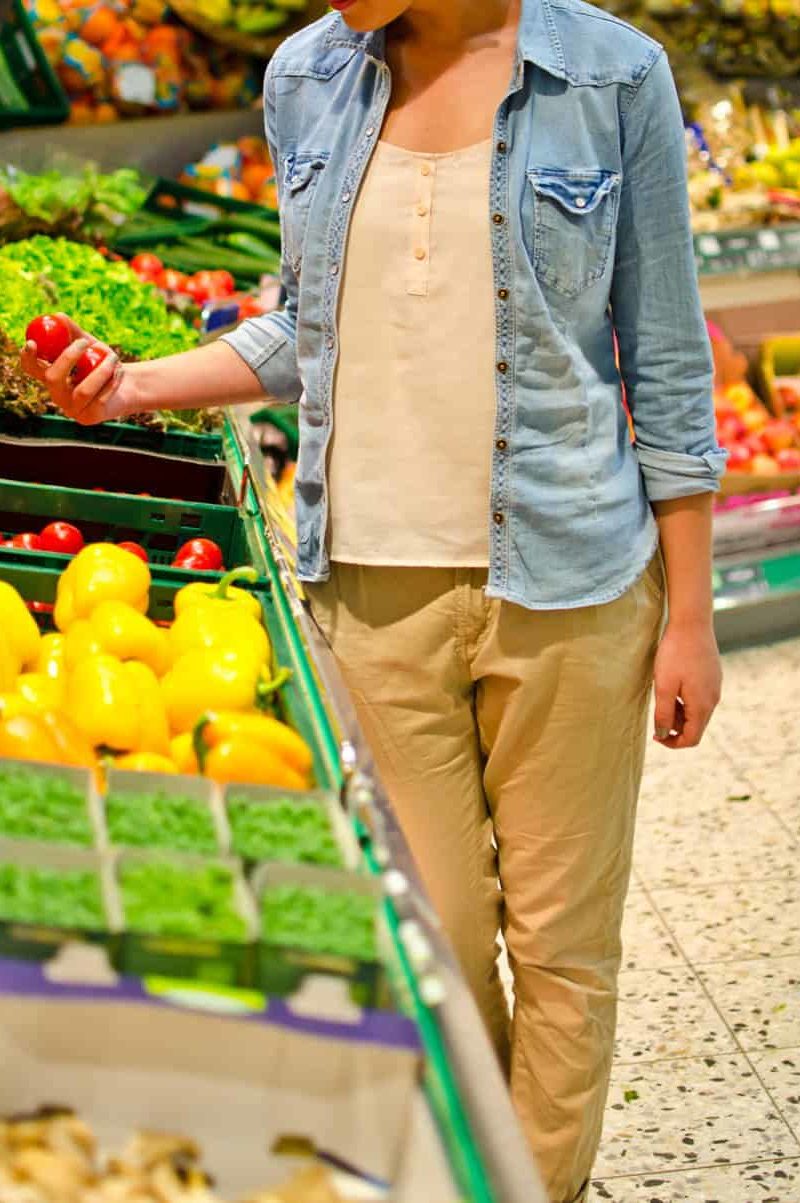 Woman holding tomatoes at produce section